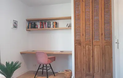 a room with a desk and a chair and a wooden door at The Blue Whale in Bergen aan Zee
