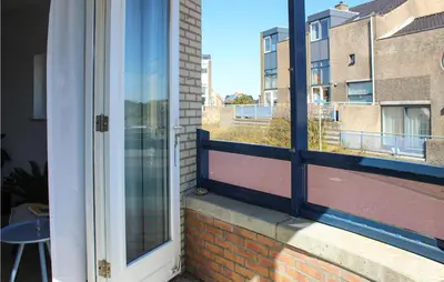 an open window with a view of a balcony at The Blue Whale in Bergen aan Zee