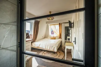 a bedroom with a bed through a glass window at Mylos Studios in Alkmaar