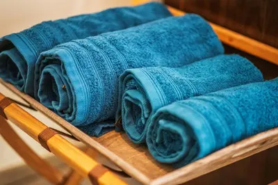a bunch of blue towels on a wooden rack at Mylos Studios in Alkmaar
