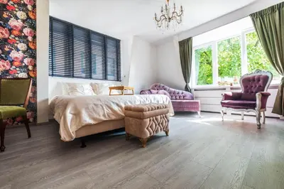 a bedroom with a bed and two chairs at Mylos Studios in Alkmaar