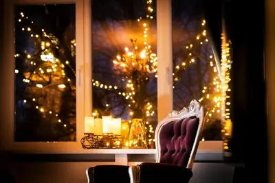 a chair in front of a window with christmas lights at Mylos Studios in Alkmaar