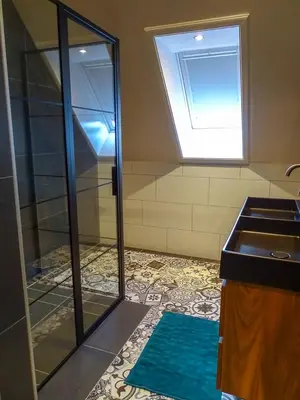 a bathroom with a shower and a sink and a window at Bed & Breakfast De Leekerhoek in Oosterleek