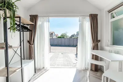 a room with a door open to a patio at Be So Suite in Zandvoort