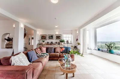 a living room with a couch and a table at Family Villa behind the Beach in Zandvoort
