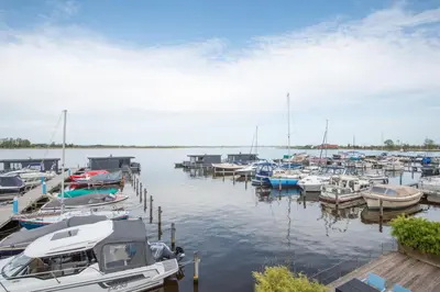 a bunch of boats docked in a harbor at Meerzicht 20 - Waanzinnig uitzicht over het water! in Uitgeest