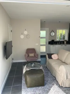 a living room with a couch and a coffee table at Klein geluk in Warmenhuizen