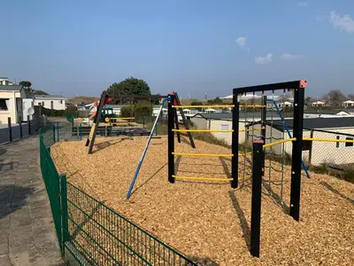 a group of swings in a playground at Chalet Ibiza in de duinen van IJmuiden aan Zee in IJmuiden