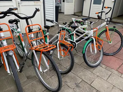 a group of bikes parked next to each other at Chalet Ibiza in de duinen van IJmuiden aan Zee in IJmuiden