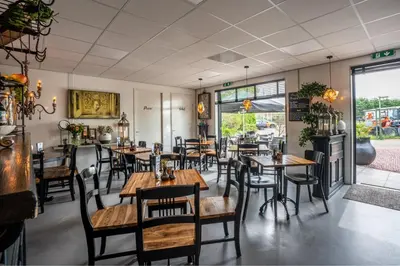 a dining room with wooden tables and chairs at Chalet Ibiza in de duinen van IJmuiden aan Zee in IJmuiden
