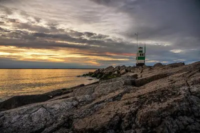 a light house on the rocks near the water at Chalet Ibiza in de duinen van IJmuiden aan Zee in IJmuiden
