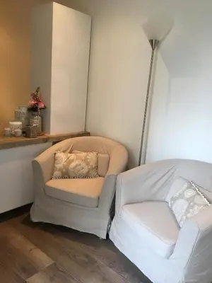 a living room with a chair and a couch at Romana in Zandvoort