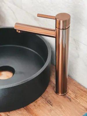 a copper water faucet on top of a sink at B&B Landslake I in Landsmeer
