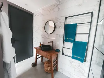 a bathroom with a wooden table and a mirror at B&B Landslake I in Landsmeer