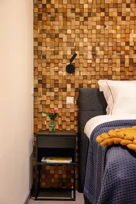 a bedroom with a bed and a vase of flowers on a night stand at LOFT 188 Luxury Apartment Hotel in Utrecht