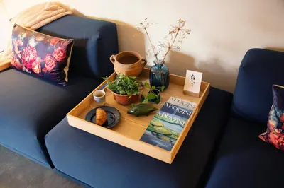 a tray on a couch with a table with a book at LOFT 188 Luxury Apartment Hotel in Utrecht