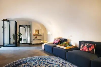 a living room with two couches and a mirror at LOFT 188 Luxury Apartment Hotel in Utrecht