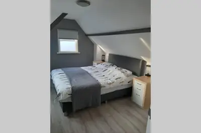 a bedroom with a large bed in a attic at Zomerhuis Strand 28 in Egmond aan Zee