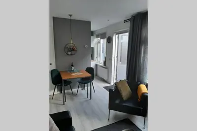 a small living room with a table and chairs at Zomerhuis Strand 28 in Egmond aan Zee