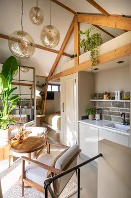 a kitchen and living room with a table and chairs at LODGE & LOFT in Sassenheim