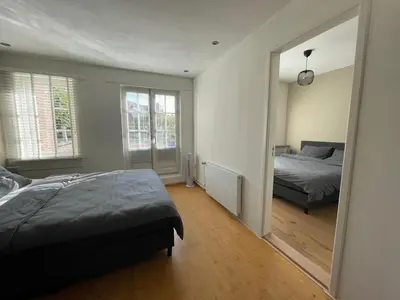 a bedroom with a bed and a mirror at Coconut Beach apartments in Zandvoort