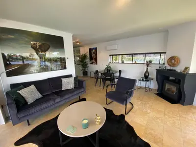 a living room with a couch and a fireplace at Water Villa Minaro Vinkeveen in Vinkeveen