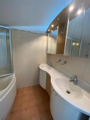 a bathroom with two sinks and a tub and a mirror at Water Villa Minaro Vinkeveen in Vinkeveen