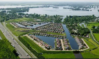 an aerial view of a large apartment complex next to a lake at Water Villa Minaro Vinkeveen in Vinkeveen