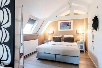 a bedroom with a large bed in a attic at Küstenwind in Zandvoort