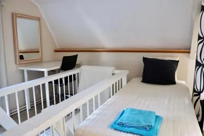 a small room with a bed and a desk at Küstenwind in Zandvoort