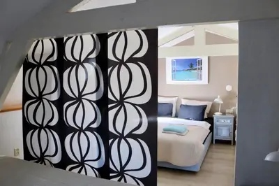 a bedroom with a bed with a black and white wall at Küstenwind in Zandvoort