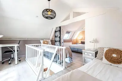 a bedroom with a bed and a desk in a room at Küstenwind in Zandvoort