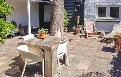 a wooden table and chairs on a patio at Paradis in Bergen