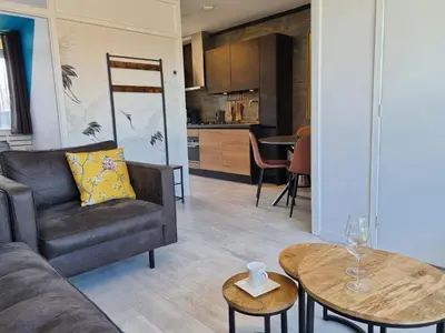 a living room with a couch and a table at De Schelp 73 the perfect place! in Zandvoort