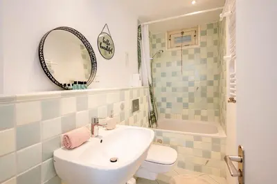 a bathroom with a sink and a toilet and a tub at Amsterdam Beach Apartment 1, Private Garden in Zandvoort