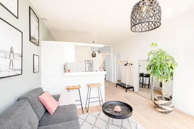 a living room with a couch and a table at Amsterdam Beach Apartment 1, Private Garden in Zandvoort