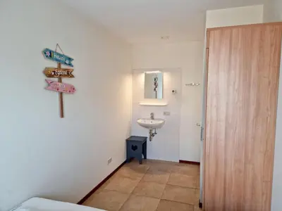 a bathroom with a sink and a mirror and a toilet at Noordzee in Egmond aan Zee