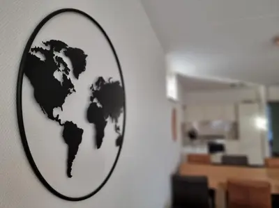 a black and white map of the world on a wall at Noordzee in Egmond aan Zee