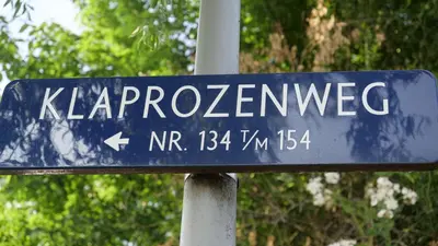 a blue street sign that reads kapplezlez at Houseboat apartment with water terrace, free bikes & fast wifi in Amsterdam