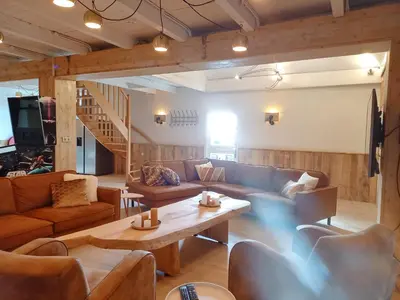 a living room with a couch and a coffee table at Pura Vida Panorama in Oud-Ade