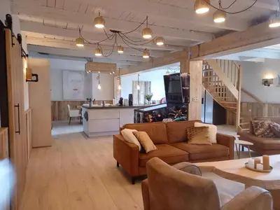 a living room with a couch and a kitchen at Pura Vida Panorama in Oud-Ade
