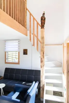 a living room with a couch and a staircase at Luna’s loft in Bergen