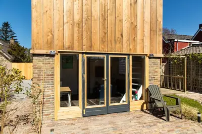 a house with a sliding glass door on a patio at Luna’s loft in Bergen