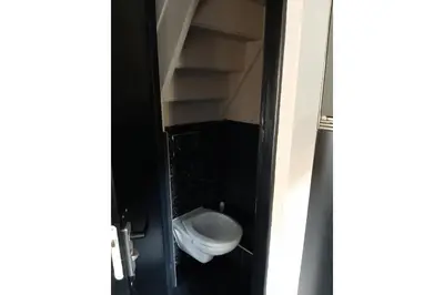 a bathroom door with a toilet in a room at Zomerhuis Adriana in Egmond aan Zee