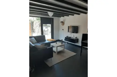 a living room with a couch and a table at Zomerhuis Adriana in Egmond aan Zee