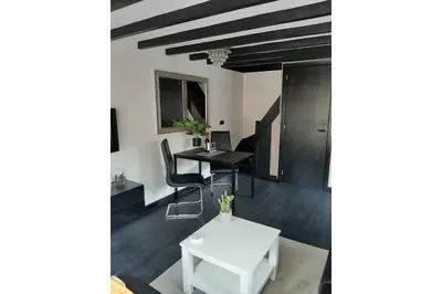 a living room with a white table and chairs at Zomerhuis Adriana in Egmond aan Zee