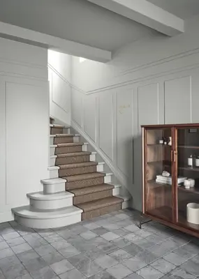 a staircase in a room with white walls at Boutique Hotel Benedict Noordwijk in Noordwijk aan Zee