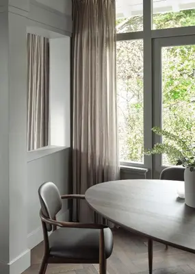 a dining room with a table and chairs and a window at Boutique Hotel Benedict Noordwijk in Noordwijk aan Zee