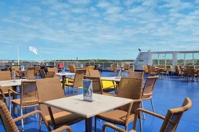 a patio with tables and chairs on a roof at DFDS Mini Cruise Amsterdam - Newcastle - Amsterdam in IJmuiden