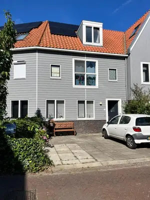 a house with a car parked in front of it at B&B Twiske Zuid, Amsterdam free parking in Amsterdam